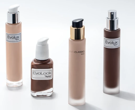 Four cosmetic foundation bottles in different shades, each with a unique reliable cosmetic pump labeled Evoclassic. The bottles are arranged neatly on a white surface.
