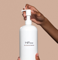 A person hands are shown pressing the pump on a white bottle labeled HiFlow E-Commerce Capable High-Dose Dispensing Pump against a plain beige background.