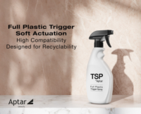 A white spray bottle labeled TSP by Aptar Full-Plastic Trigger Spray Pump sits on a white surface with a soft shadow against marble. Text reads: Full Plastic Trigger Soft Actuation. High Compatibility. Designed for Recyclability.
