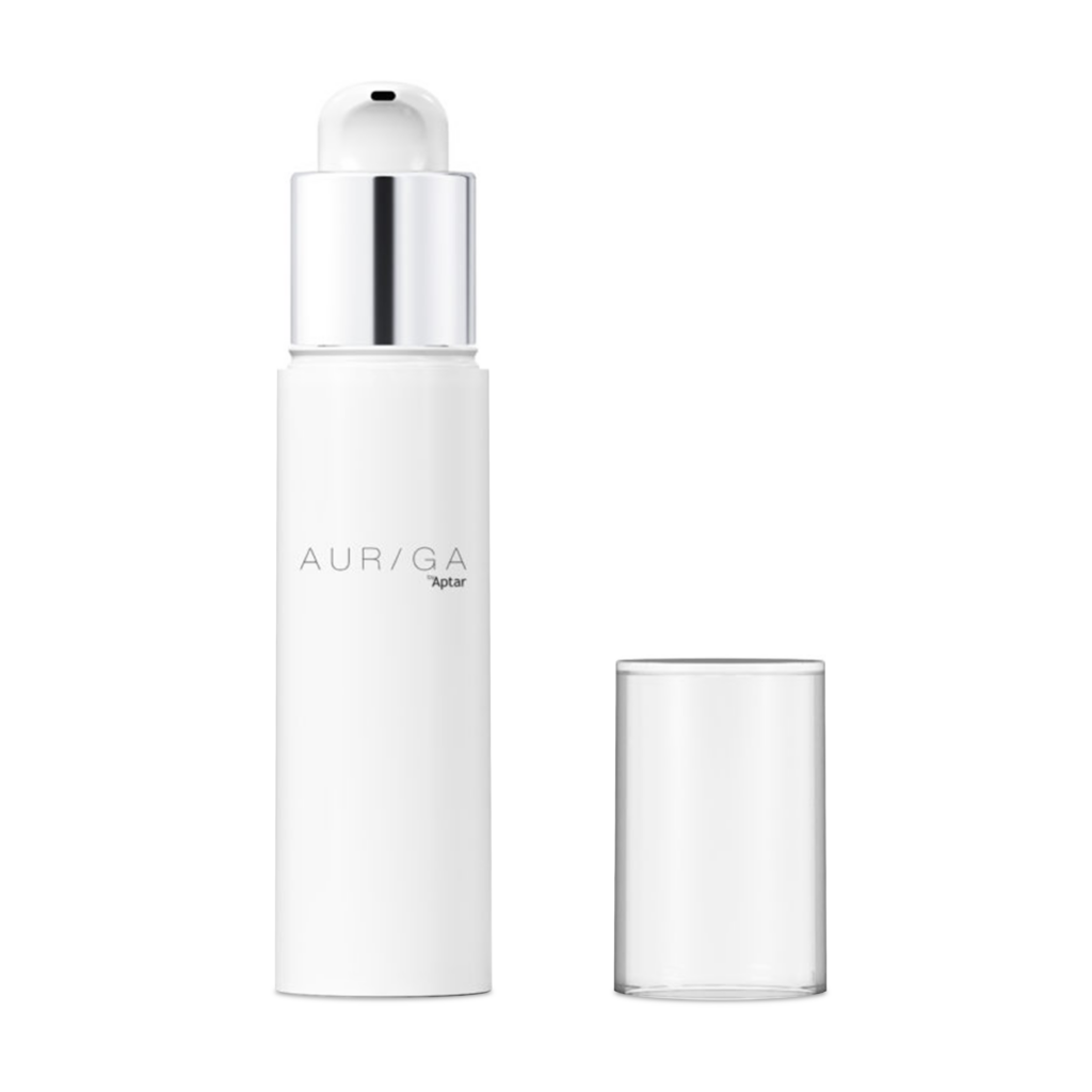 A white cylindrical skincare bottle labeled AURIGA with a metallic pump dispenser, shown next to its clear cap on a plain white background, exemplifies premium airless beauty packaging.