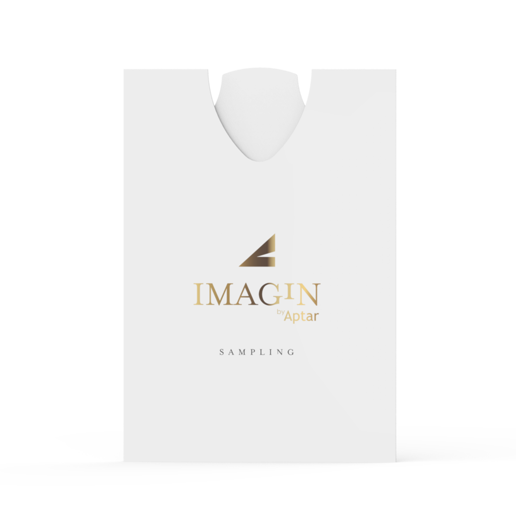 A white rectangular ultra-flat fragrance sampling pouch with a rounded top opening, displaying the gold and black IMAGIN by Aptar logo and the word SAMPLING below. The design is minimalistic and clean.