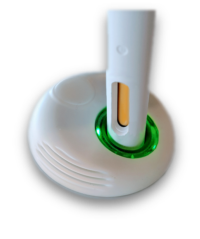 close up electronic base of an autoinjector training device with green light