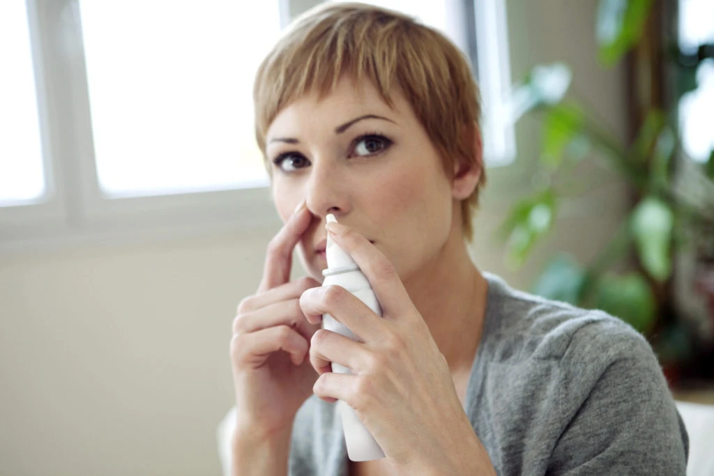 Young_woman_using_nasal_spray-scaled-1024x683.jpg