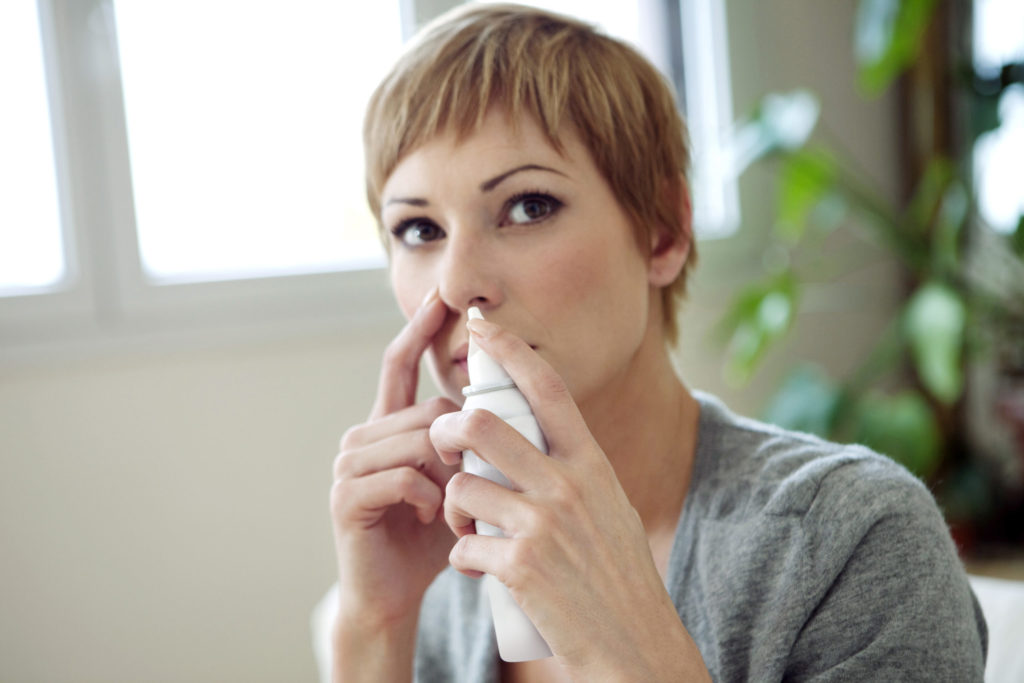 Young_woman_using_nasal_spray-scaled-1024x683.jpg