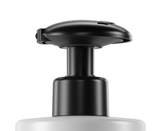Close-up of Vita, a black push down dispensing pump on top of a white bottle, set against a plain white background.