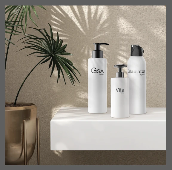 Three white bottles labeled GSA, Vita, and Gladiator displayed on a white shelf, with the Gladiator bottle featuring an ergonomically-designed aerosol actuator.