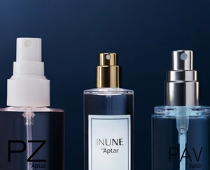 PZ by Aptar, INUNE by Aptar, and PAV by Aptar spray pumps are displayed side by side on clear bottles, featuring white, gold, and silver finishes against a dark blue background.