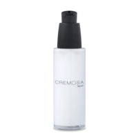 A clear cylindrical pump bottle with a black dispenser and cap, labeled CREMOSA Aptar, features an elegant cosmetic pump and contains a white liquid or cream.