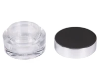 A clear, empty loose powder jar with a shiny silver base is shown with its matching black-and-silver lid placed next to it on a white background, ideal for those seeking premium custom cosmetic packaging manufacturer solutions.