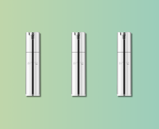 Three sleek, silver cylindrical bottles labeled Auriga City are evenly spaced against a soft green-to-blue gradient background. Each features luxury airless packaging with a minimalist design, subtle text, and a spray nozzle on top.