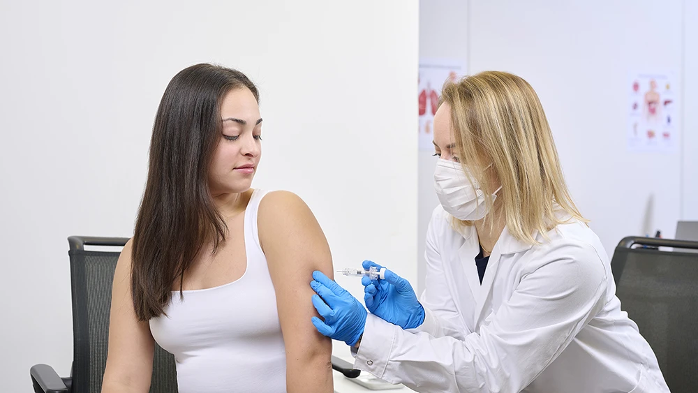 Patient receives an injection in the arm with a pre-filled-syringe