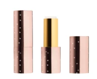 Aptar Beauty's L1512 non-guided lipstick packaging is displayed in three parts: a closed rose gold tube, an open version revealing the product inside, and the cap placed separately.