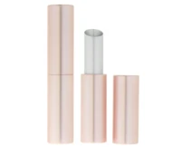 A metallic rose gold case with guided lipstick packaging stands upright, cap removed to reveal the product inside. The cap rests elegantly beside the open tube.