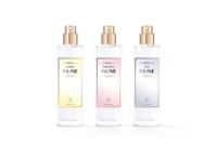 Three clear spray bottles with gold tops, labeled Refill Classic INUNE Aptar, Refill Precious INUNE Aptar, and Refill HDS INUNE Aptar, each with a subtle yellow, pink, or gray gradient featuring a refillable prestige fragrance pump design.