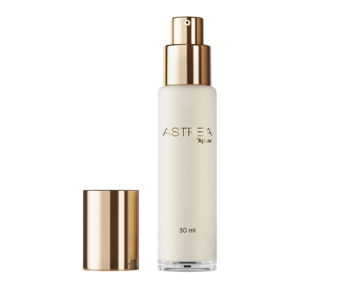 A single, elegant bottle stands upright against a clean, white background. The packaging features Aptar Beauty’s Astrea airless glass dispenser, highlighted by a luxurious gold actuator and matching cap placed beside it.