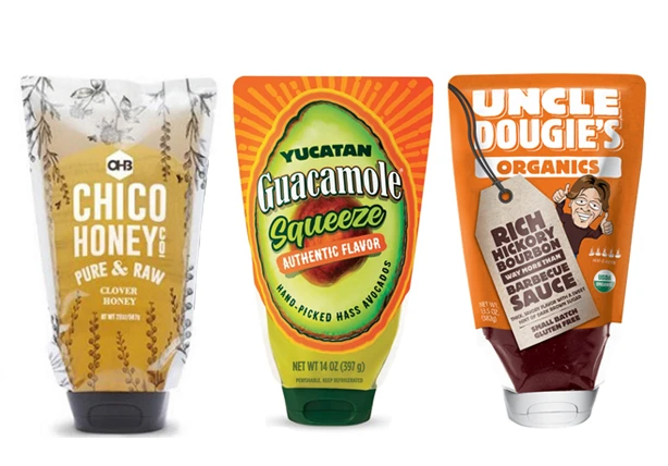 3 products showcasing Aptar's market-distrupting standcap inverted pouch solution. From left to right: Chico Honey, Yucatan Guacamole and Uncle Dougie's Organic BBQ sauce