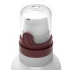 Close-up of PZ3 ,a high-performing pump for viscous formulas, featuring a white nozzle with a maroon-colored collar and a transparent cap, mounted on a gray bottle neck, set against a plain white background.