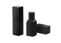 Two black non guided mini lipstick packaging, one closed and one open to reveal the white balm inside, are placed on a white background. Another black cap lies next to the open tube.
