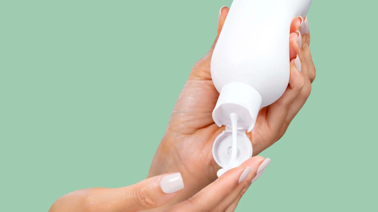 Embrace personal care closure in use, hands squeezing lotion