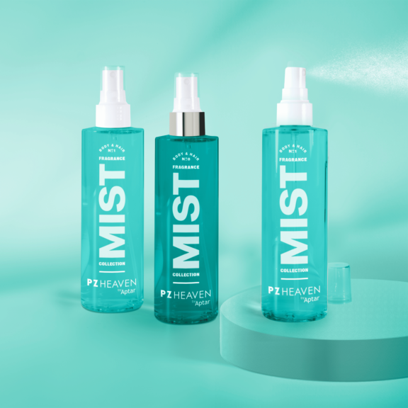 Three turquoise spray bottles labeled MIST COLLECTION and PZ HEAVEN Aptar, each featuring a Classic Fine Mist Spray Pump, are displayed on a teal background, with one bottle cap removed and lying nearby on a round platform.