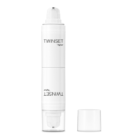 A white dual-chamber pump bottle labeled TWINSET Aptar, designed with innovative 2-in-1 Airless Packaging, stands upright with a clear plastic cap placed next to it on a white background.