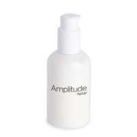 A white plastic bottle with a pump dispenser features the label Amplitude by Aptar on the front, showcasing a high dose cosmetic pump for precise and efficient product dispensing.