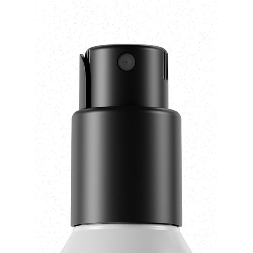 Close-up of a black twist-to-lock-spray pump named PZ Twist on top of a white bottle, set against a plain white background.