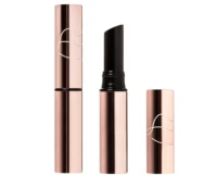 A rose gold guided lipstick packaging tube with a curved design, shown closed, open with the black lipstick exposed, and with the cap placed beside it.