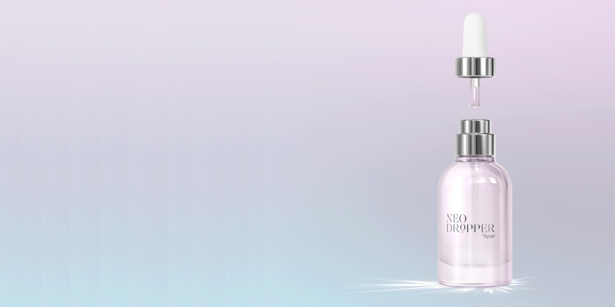 A clear glass bottle labeled NEO DROPPER with elegant dropper packaging and a silver cap, set against a soft pastel gradient background. The dropper floats above the bottle, with a single drop about to fall.