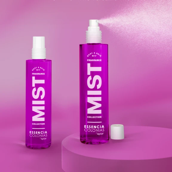 Two purple bottles labeled Fragrance MIST COLLECTION on a pink background