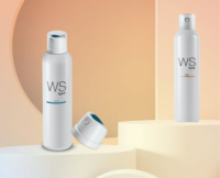 Two white bottles labeled WS55 by Aptar, featuring a Bicolor Aerosol Actuator, with a clear cap are displayed on geometric pastel platforms.