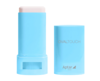 Two light blue Oval Touch on-the-go oval face stick containers labeled OVALTOUCH and Aptar beauty, standing upright against a soft blue gradient background. The first one is closed, middle container is open, revealing the white sick inside followed by the one cap.