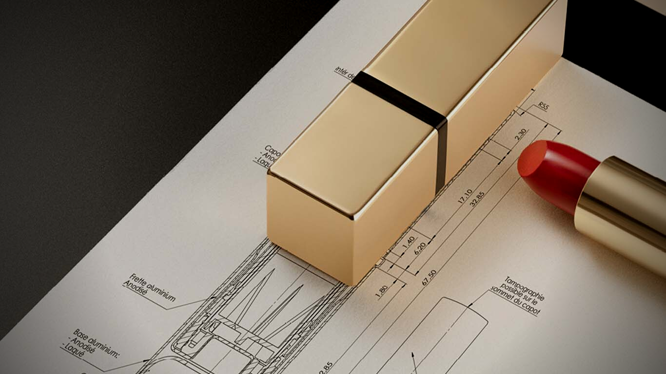 A gold lipstick tube featuring a Non-Guided Lipstick Mechanism labeled Iconic and its cap rest on a technical drawing, the bold red lipstick partially uncapped. The dark background highlights the elegant design.