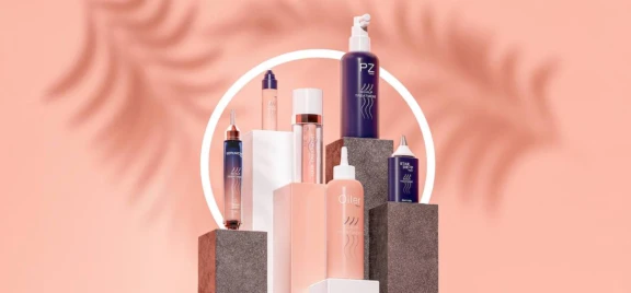 Aptar's targeted application collection, featuring Softips, a beauty treatment applicator, along with Serumony and PZ is arranged on geometric platforms against a peach backdrop.