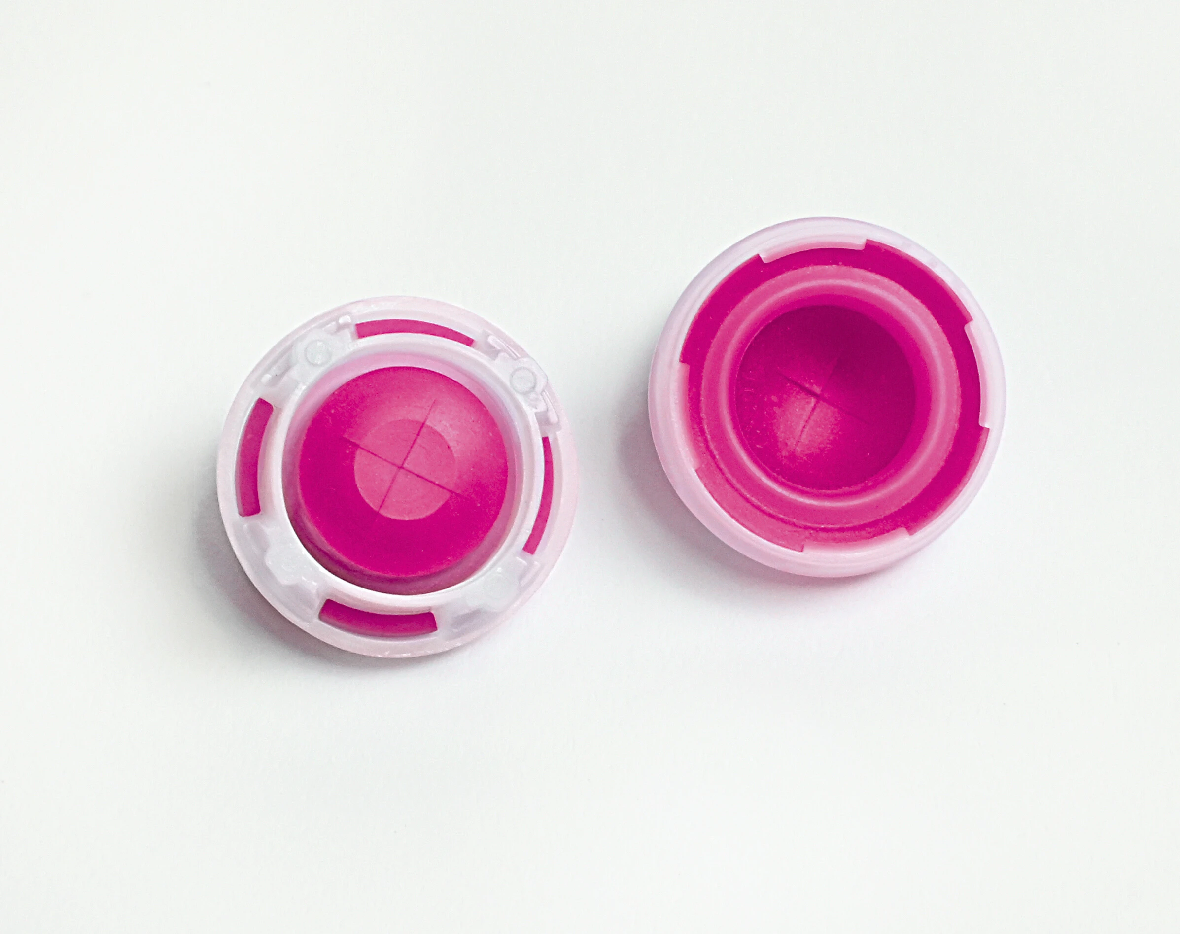 two colorful SureSnap two-in-one pre-assembled valves and retaining ring