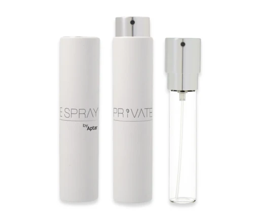 Three refillable fragrance purse spray bottles are shown: two with white outer cases and silver caps, and one clear glass bottle with a silver spray top, revealing the inner mechanism. All bottles stand upright.