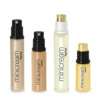 Four bottles of skincare cream labeled minicream by Aptar, each with a pump dispenser and in shades of beige, brown, clear, and yellow, showcase stylish mini packaging in various shapes and sizes.