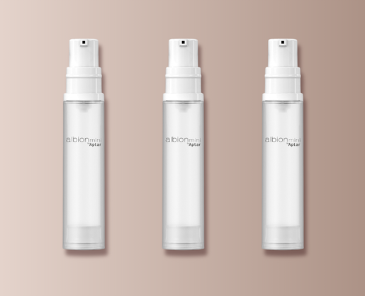 Three identical clear spray bottles labeled Albion Mini by Aptar are arranged in a row on a beige background. Each bottle features a white pump and showcases Aptar's travel-friendly mini airless packaging,designed for convenience and freshness on the go.