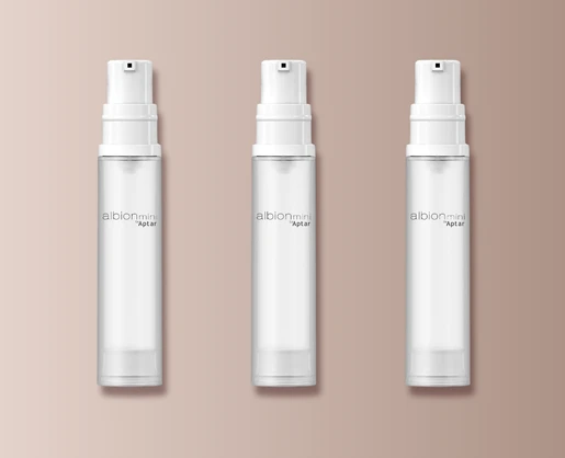 Three identical clear spray bottles labeled Albion Mini by Aptar are arranged in a row on a beige background. Each bottle features a white pump and showcases Aptar's travel-friendly mini airless packaging,designed for convenience and freshness on the go.