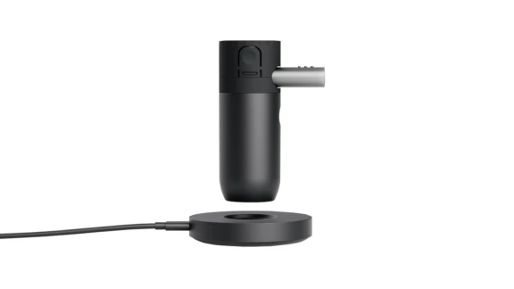 Side view of black cylindrical Aptar Kolibri NPLI above corded base used to deliver liquid droplets to lungs.