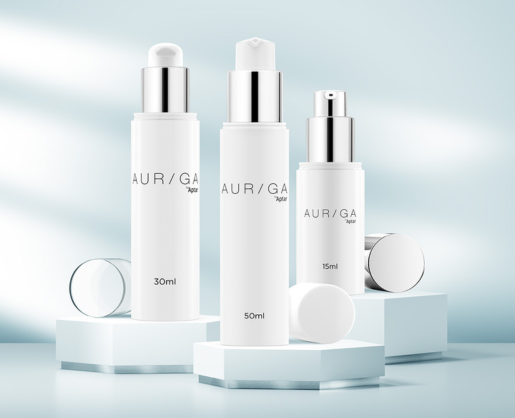 Three white cylindrical skincare bottles labeled AUR/GA with 30ml, 50ml, and 15ml capacities are displayed on white hexagonal platforms, showcasing premium airless beauty packaging against a soft blue background with light reflections.