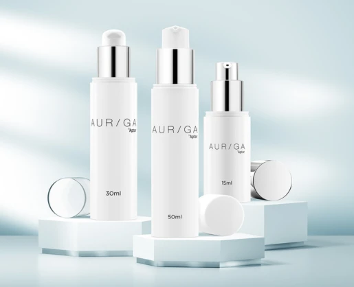 Three white cylindrical skincare bottles labeled AUR/GA with 30ml, 50ml, and 15ml capacities are displayed on white hexagonal platforms, showcasing premium airless beauty packaging against a soft blue background with light reflections.