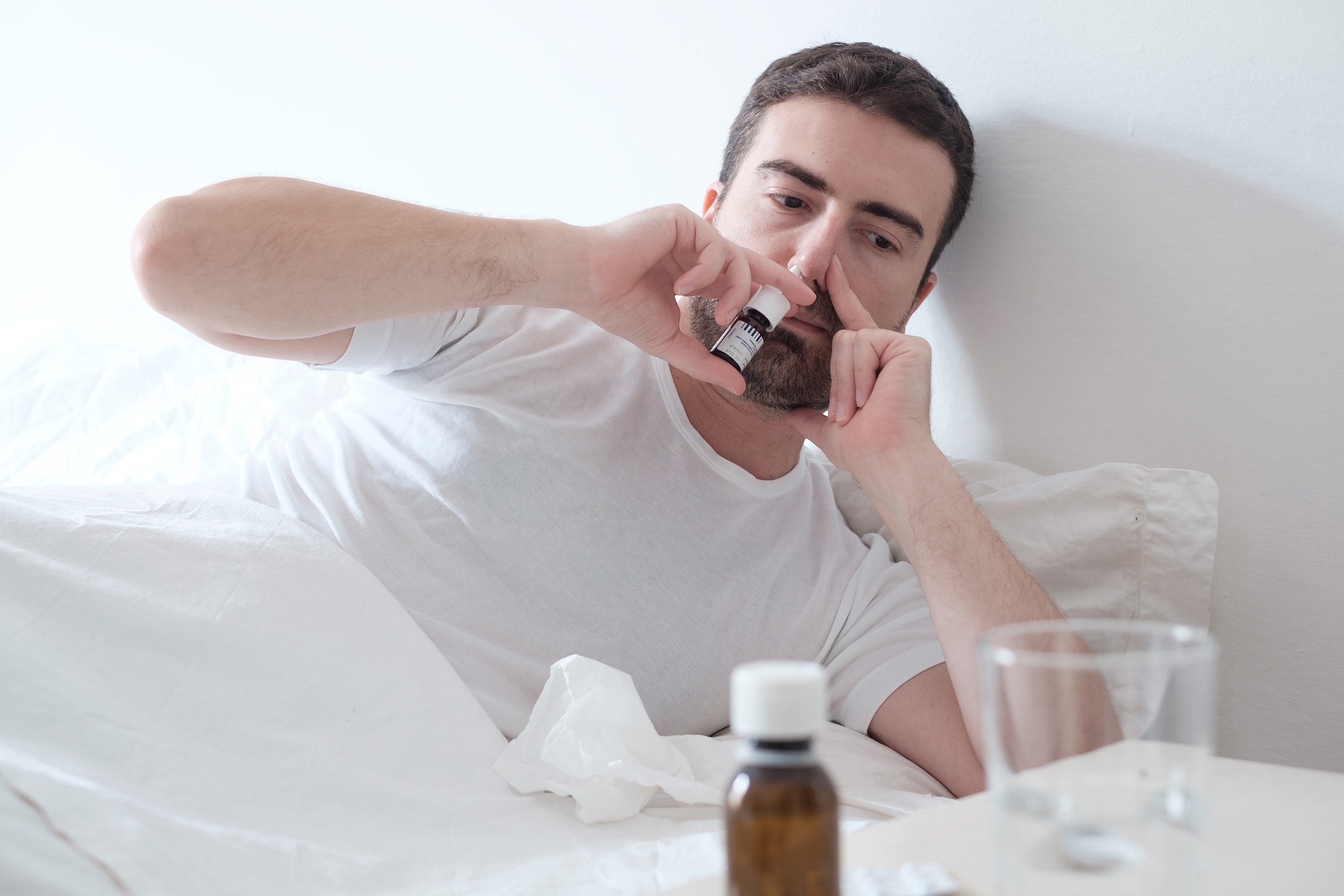 patient using multi-dose nasal spray device