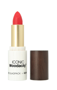 A red lipstick with a Non-Guided Lipstick Mechanism comes in a white and gold ICONIC Woodacity tube, its dark wood-like cap placed beside it, all set against a white background.