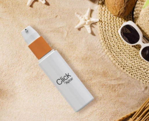A white Lotion Cosmetic Pump labeled Click Lotion lies on sand near sunglasses, a woven hat, a starfish, and pieces of coconut, evoking a relaxing beach scene.