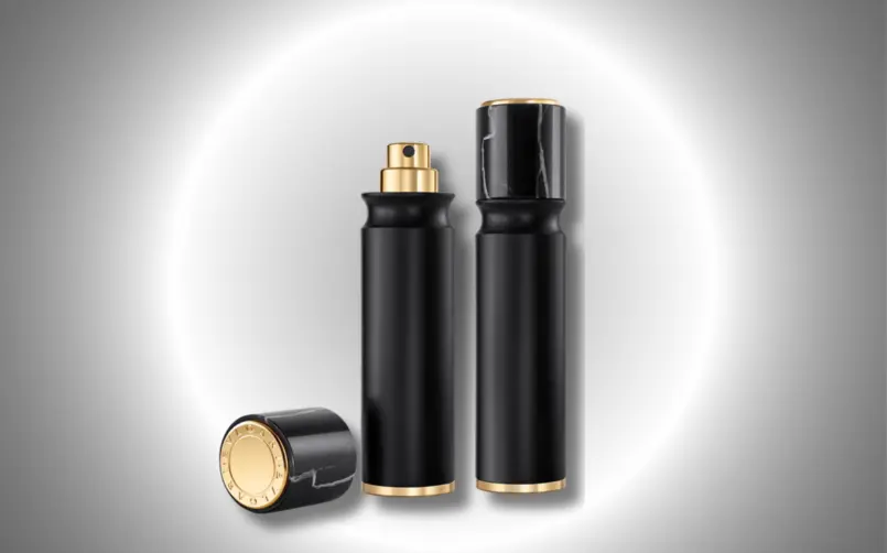 A Refillable Travel Spray by Bvlgari using Aptar Beauty's Nomad Refill with a black matte casing and marble cap with gold