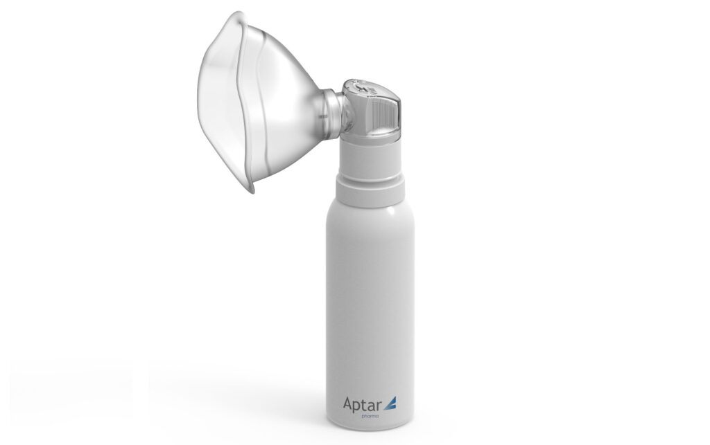 Aptar Pharma's PureHale fine mist dispensing system in white fitted with mask attachment standing on a white background.