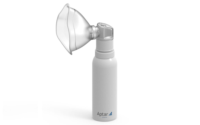 Aptar Pharma's PureHale fine mist dispensing system in white fitted with mask attachment standing on a white background.