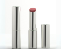Three metallic lipstick tubes are shown: one closed, one open displaying a pinkish-red shade with a Guided Lipstick Mechanism from the Stylist Guided Lipstick Mechanism collection, and one cap lying beside them, all against a plain white background.