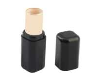 A black and gold non-guided lipstick packaging, with the matching black cap placed beside it on a white background.